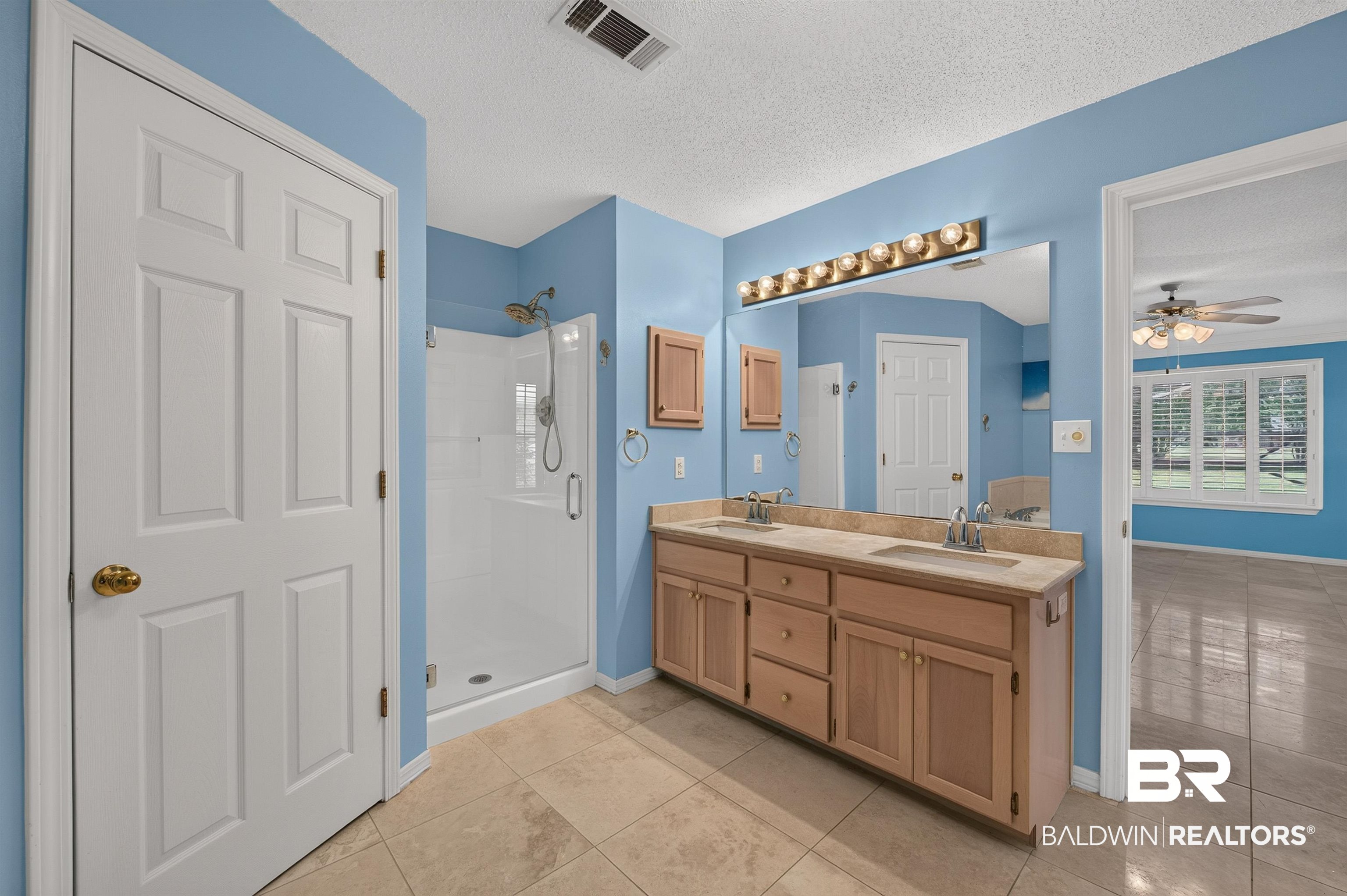 22685 County Road 12 Foley, AL 36535 - Photo 56 of 89 Bathroom featuring a dual vanity with light-wood cabinetry and a large mirror