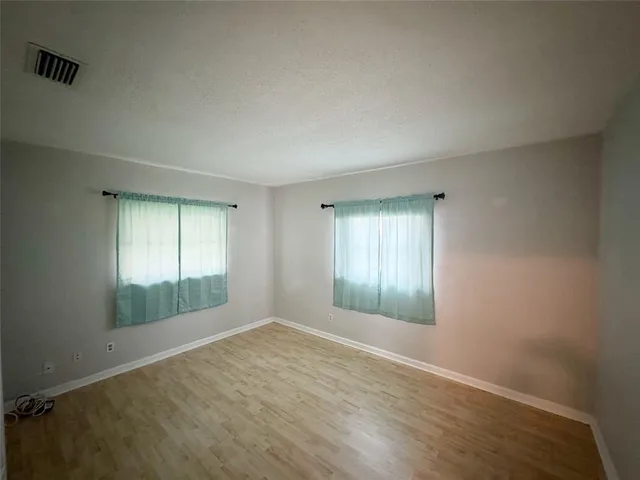 a view of a room with workspace and windows