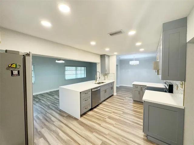 a large kitchen with a large counter top appliances and cabinets