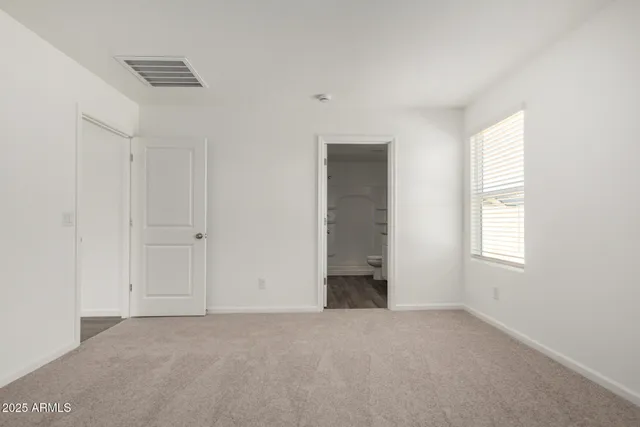a bathroom with a granite countertop sink a toilet and a mirror