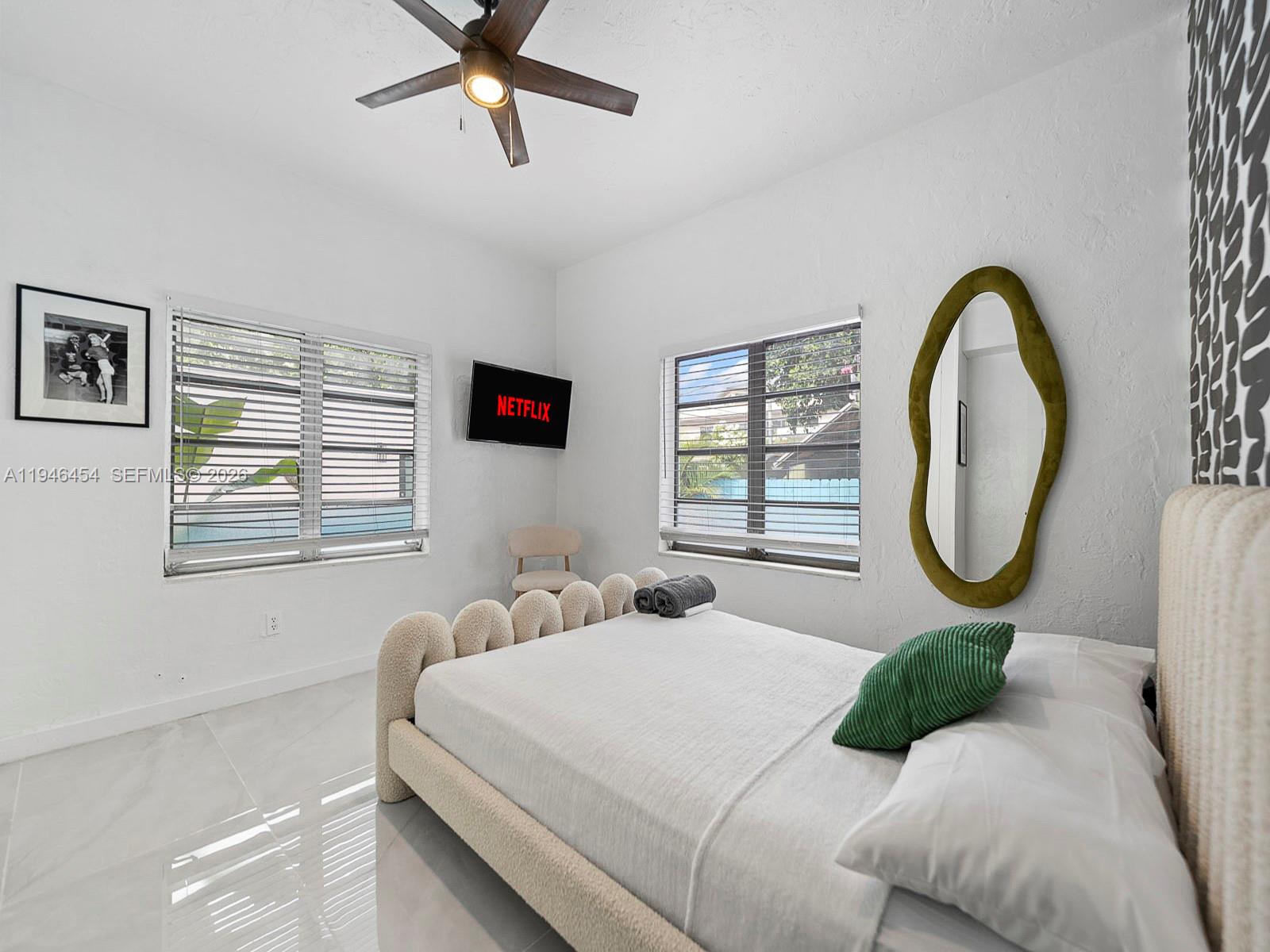 1845 Southwest 9th Street Miami, FL 33135 - Photo 11 of 31 a bedroom with a bed a mirror and a window