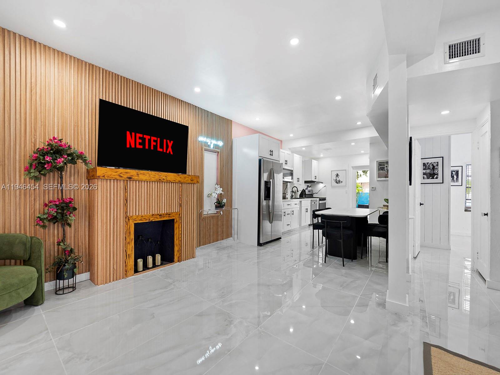 1845 Southwest 9th Street Miami, FL 33135 - Photo 4 of 31 a living room with furniture a fireplace and a flat screen tv