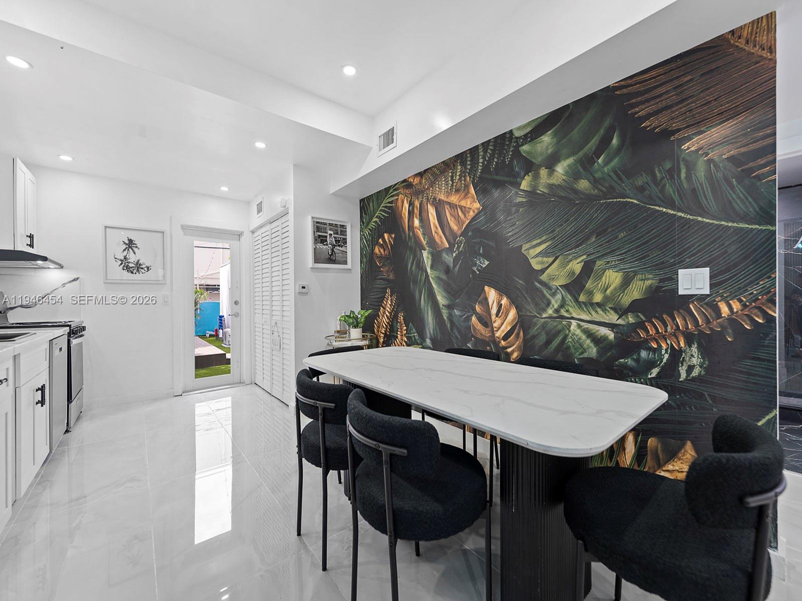 1845 Southwest 9th Street Miami, FL 33135 - Photo 7 of 31 a view of a dining room with furniture and wooden floor