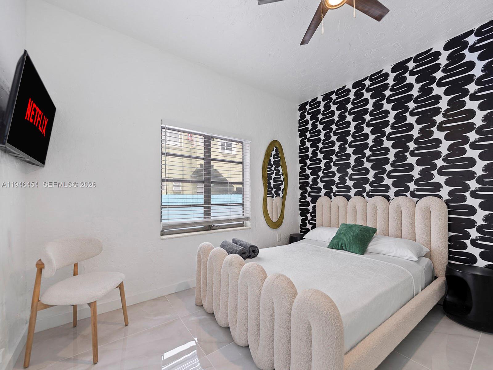 1845 Southwest 9th Street Miami, FL 33135 - Photo 10 of 31 a bed room with a bed and a television