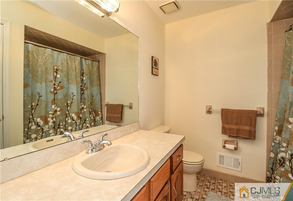 7 Paddock Court Edison, NJ 08820 - Photo 14 of 23 a bathroom with a sink toilet and shower
