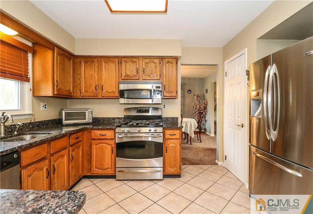 7 Paddock Court Edison, NJ 08820 - Photo 17 of 23 a kitchen with stainless steel appliances granite countertop a refrigerator stove and sink