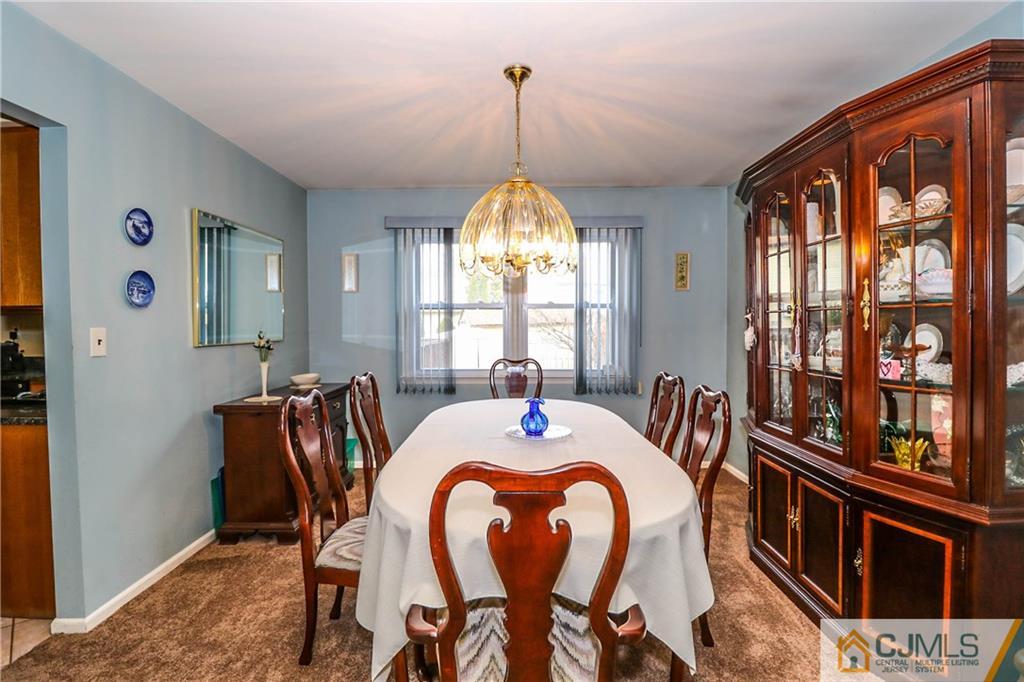7 Paddock Court Edison, NJ 08820 - Photo 3 of 23 a view of a dining room with furniture window and wooden floor