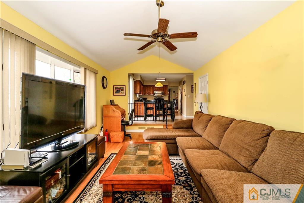 7 Paddock Court Edison, NJ 08820 - Photo 6 of 23 a living room with furniture and a flat screen tv