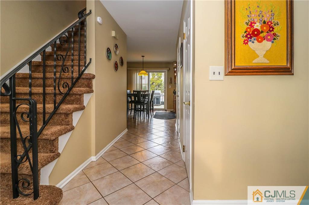 7 Paddock Court Edison, NJ 08820 - Photo 7 of 23 a view of a hallway with wooden floor and stairs