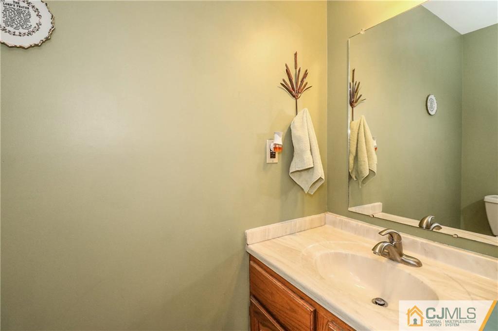 7 Paddock Court Edison, NJ 08820 - Photo 9 of 23 a bathroom with a sink and a mirror