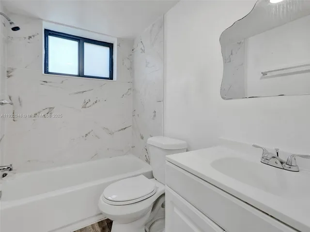 a bathroom with a sink a toilet and a bathtub