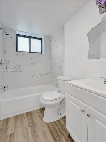 a bathroom with a toilet a sink and bathtub