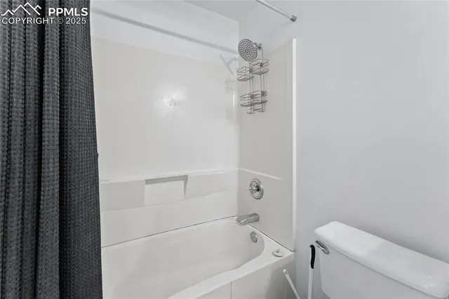 a bathroom with a bathtub and toilet