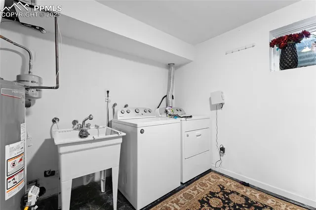 a utility room with sink dryer and washer