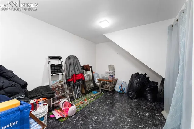 a living room with furniture a rug and white walls