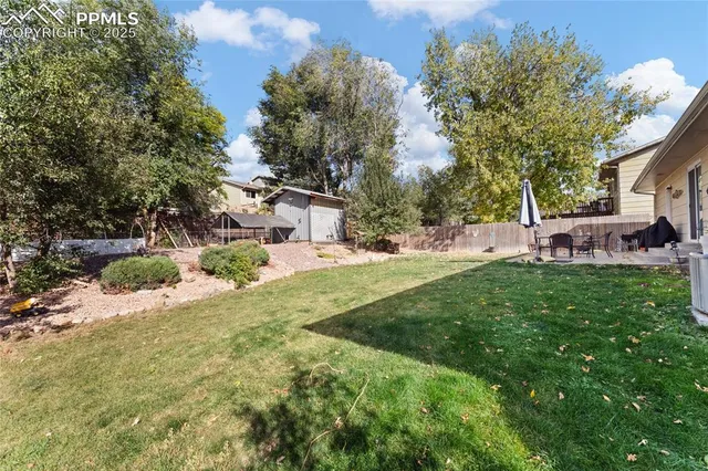 a view of backyard of house with green space
