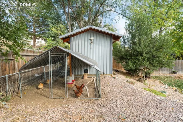 a view of backyard of house with seating space