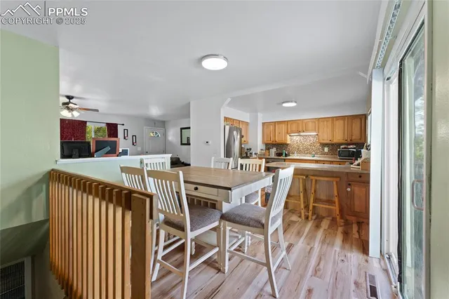 a view of a dining room kitchen with furniture and wooden floor