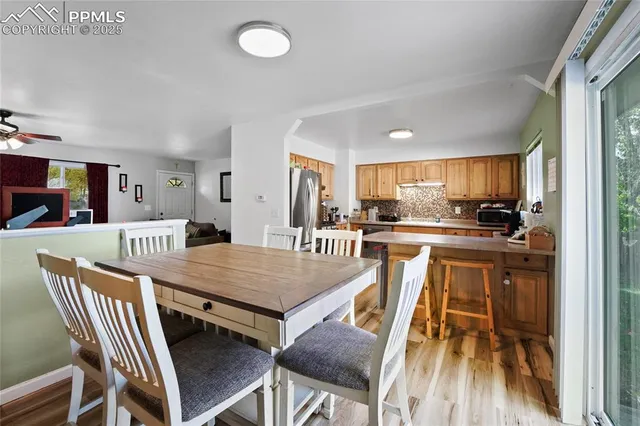a dining room with furniture and wooden floor