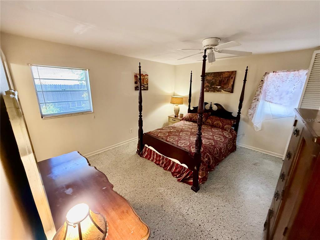 1004 Connecticut Road Tarpon Springs, FL 34689 - Photo 25 of 57 a bed room with a bed window and a chair