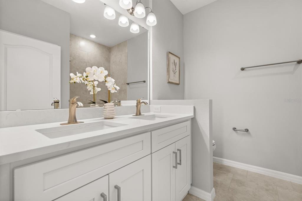 6143 Monegro Street Sebring, FL 33872 - Photo 18 of 25 a bathroom with a sink vanity and a mirror