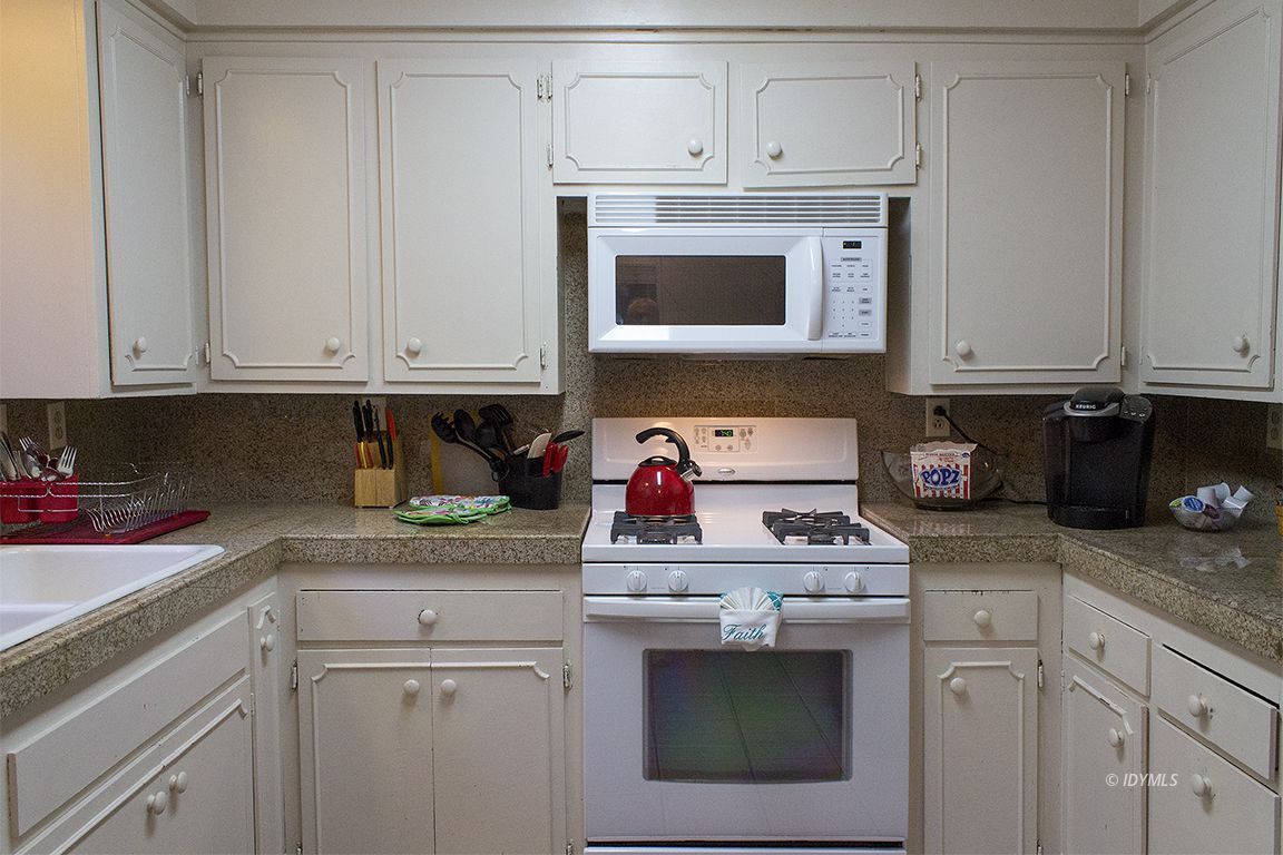 54955 South Circle Drive Idyllwild, CA 92549 - Photo 18 of 31 a kitchen with white cabinets and white appliances