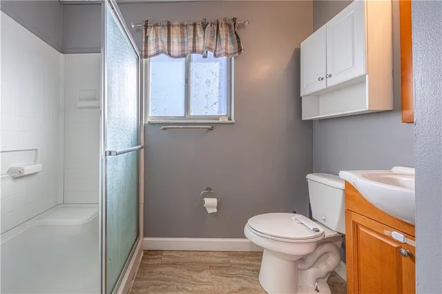 a bathroom with a toilet and a shower