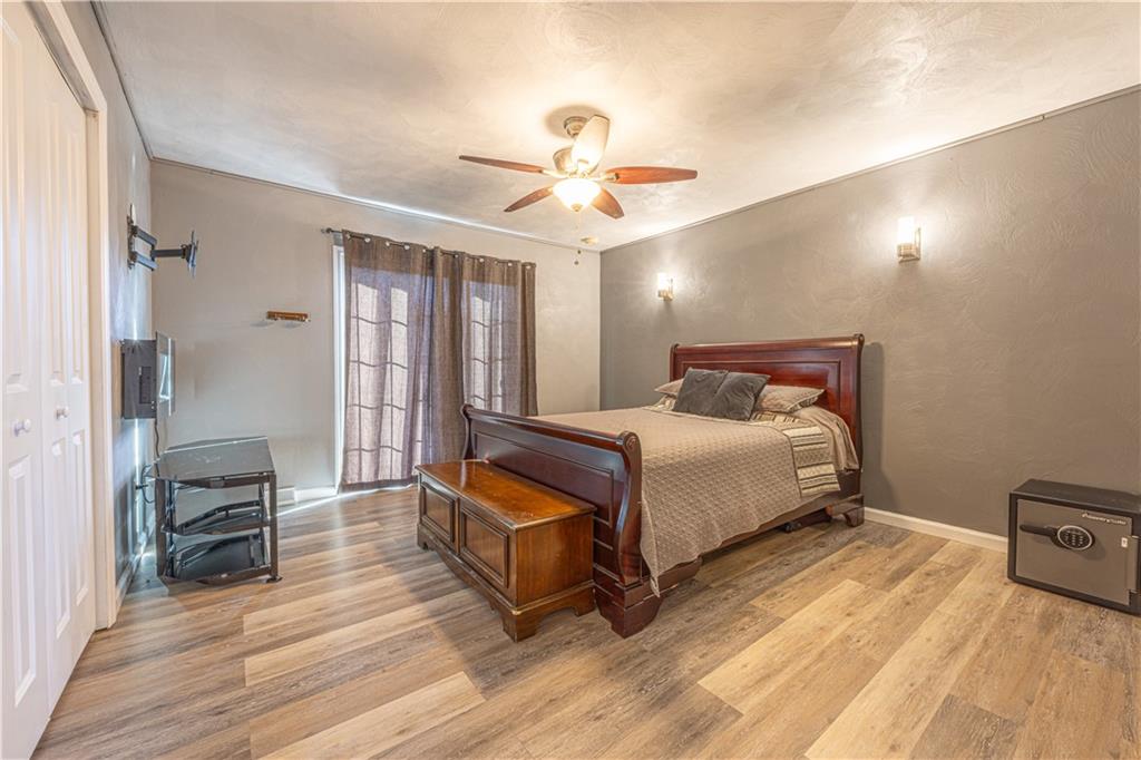 411 McClellandtown Road Uniontown, PA 15401 - Photo 20 of 33 a bedroom with a bed and wooden floor