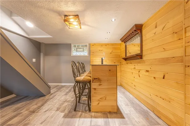 a reading room with wooden floor and furniture