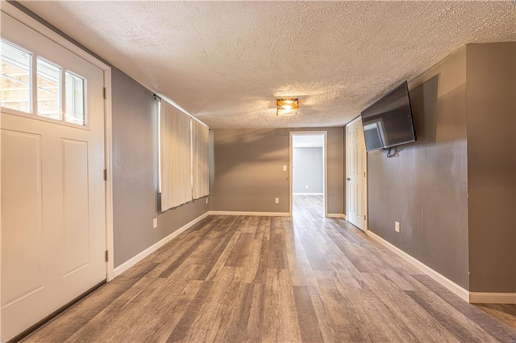 411 McClellandtown Road Uniontown, PA 15401 - Photo 23 of 33 a view of empty room with wooden floor and fan