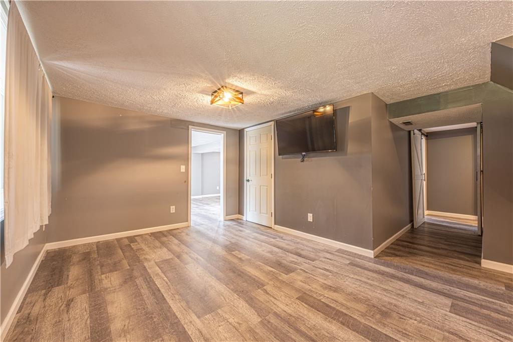 411 McClellandtown Road Uniontown, PA 15401 - Photo 24 of 33 a view of empty room with wooden floor and fan