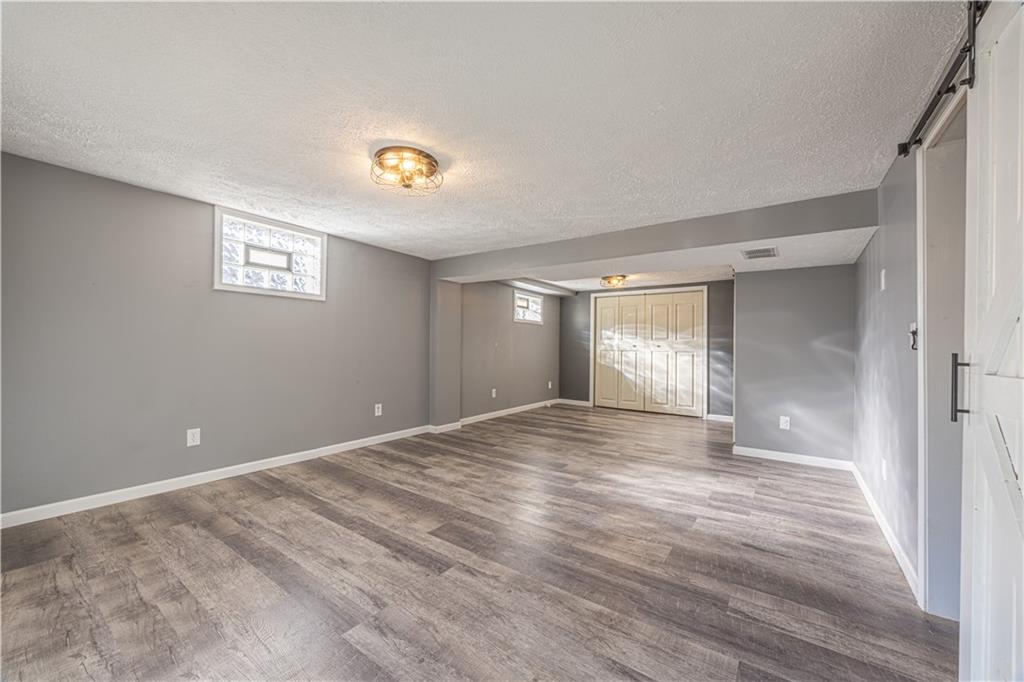 411 McClellandtown Road Uniontown, PA 15401 - Photo 25 of 33 a view of an empty room with window and wooden floor