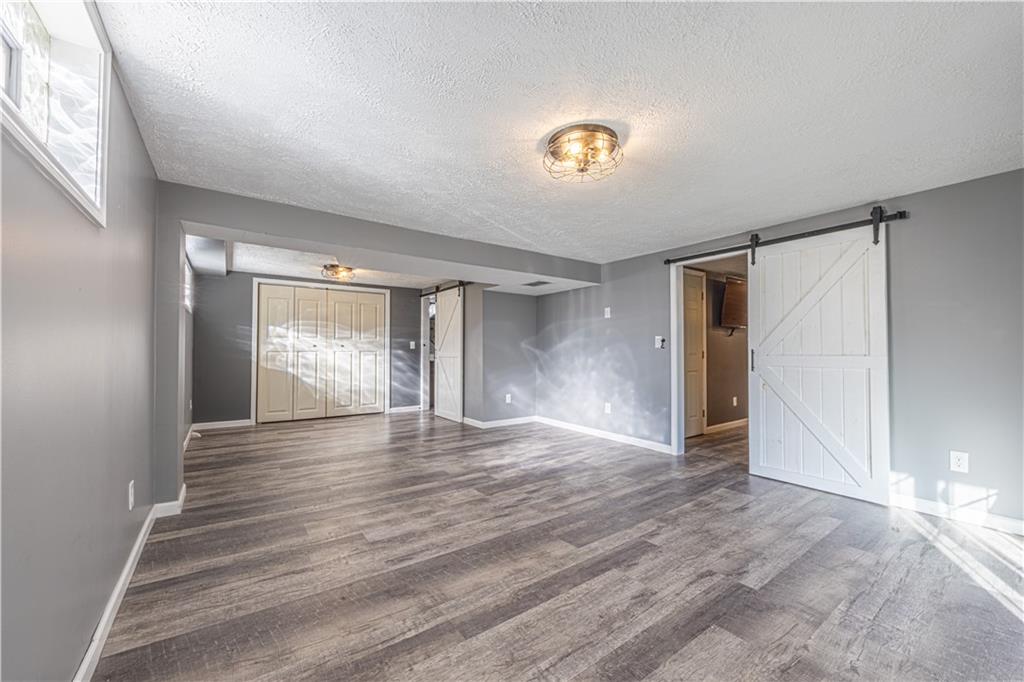 411 McClellandtown Road Uniontown, PA 15401 - Photo 26 of 33 a view of an empty room with window and wooden floor