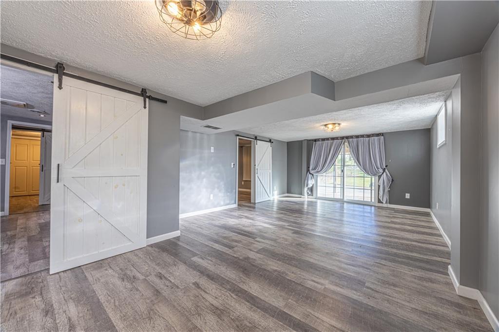 411 McClellandtown Road Uniontown, PA 15401 - Photo 27 of 33 an empty room with wooden floor and windows