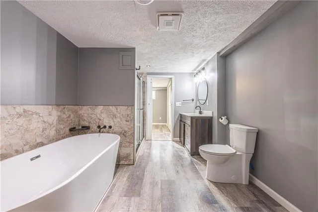 a spacious bathroom with a bathtub sink and toilet