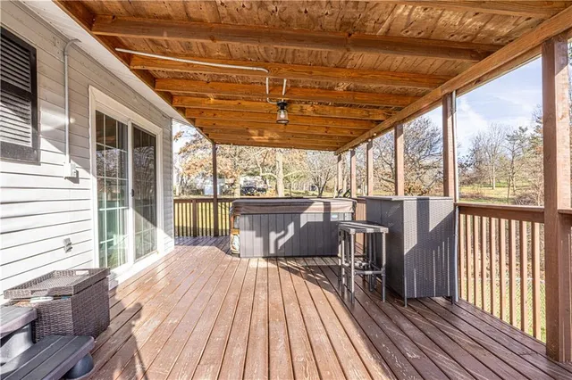 a view of a balcony with furniture and wooden floor