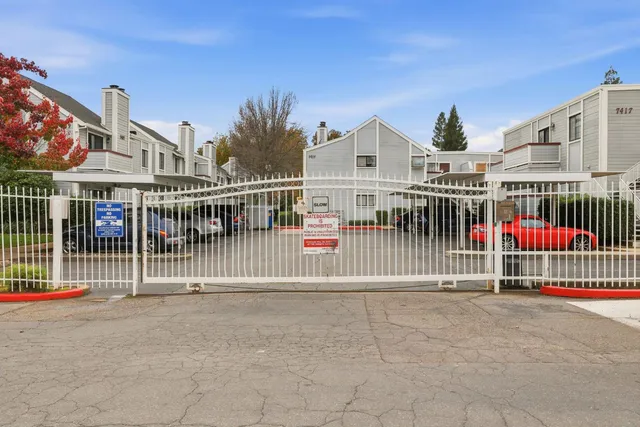 a view of a house with iron fence