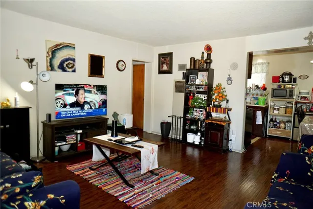 a living room with lots of furniture and wooden floor