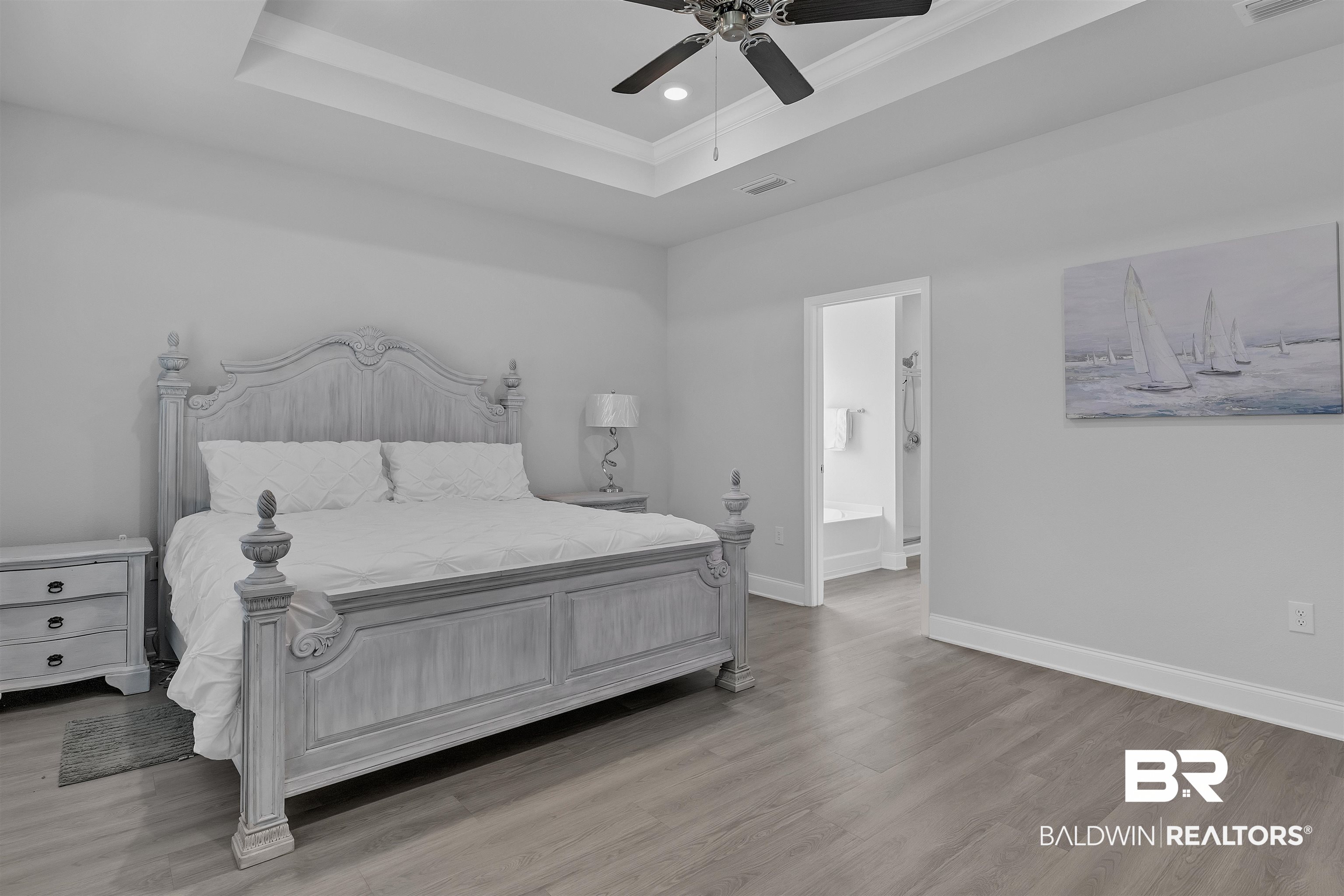 27862 Jade Court Daphne, AL 36526 - Photo 26 of 33 Bedroom with visible vents, baseboards, wood finished floors, and a raised ceiling