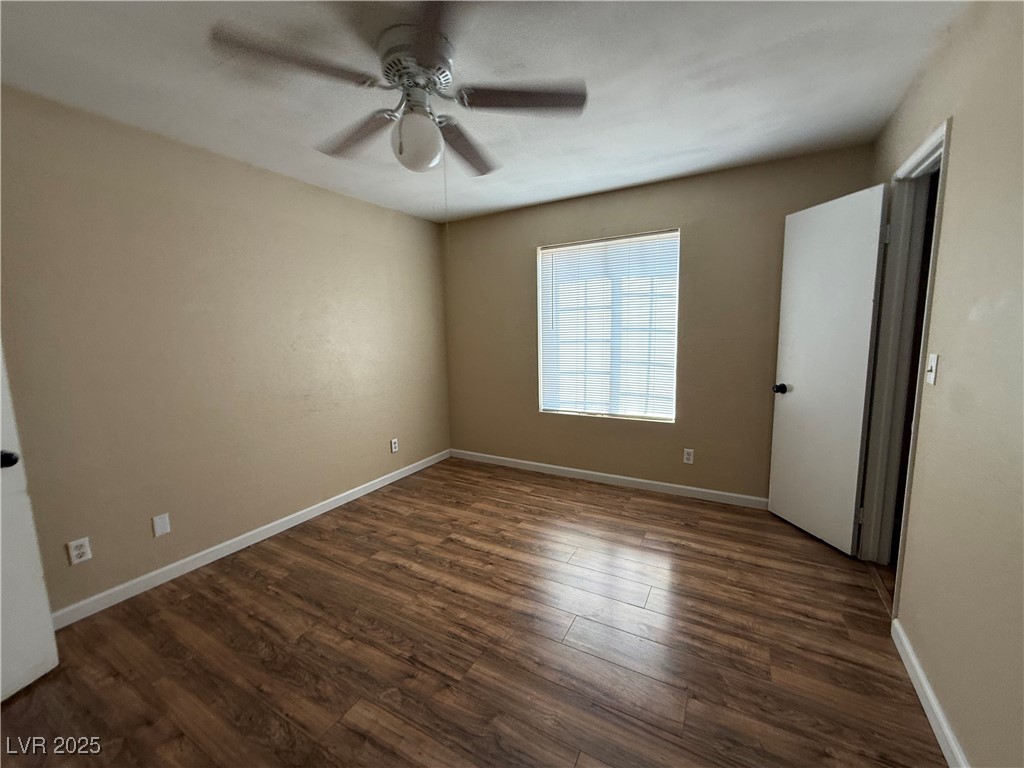2200 South Fort Apache Road, Unit 1001 Las Vegas, NV 89117 - Photo 5 of 7 Unfurnished bedroom with dark wood-style floors and a ceiling fan