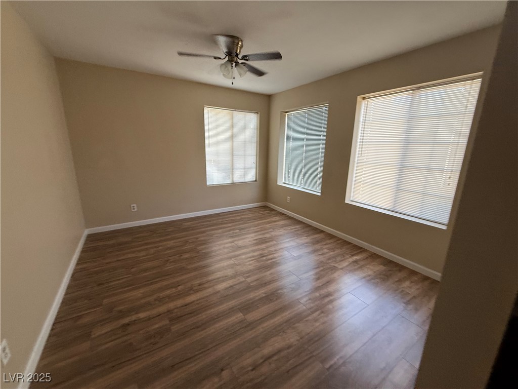 2200 South Fort Apache Road, Unit 1001 Las Vegas, NV 89117 - Photo 6 of 7 Unfurnished room featuring dark wood-style floors and ceiling fan