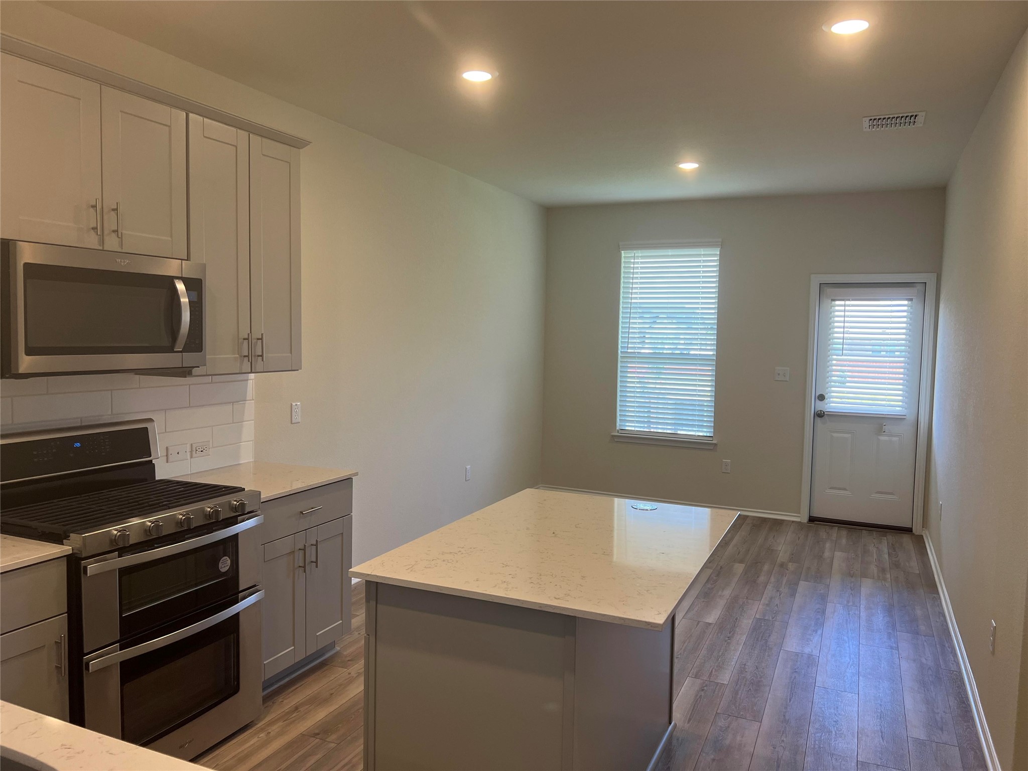 427 Tree Nut Loop Buda, TX 78610 - Photo 8 of 38 a kitchen with a stove and a microwave