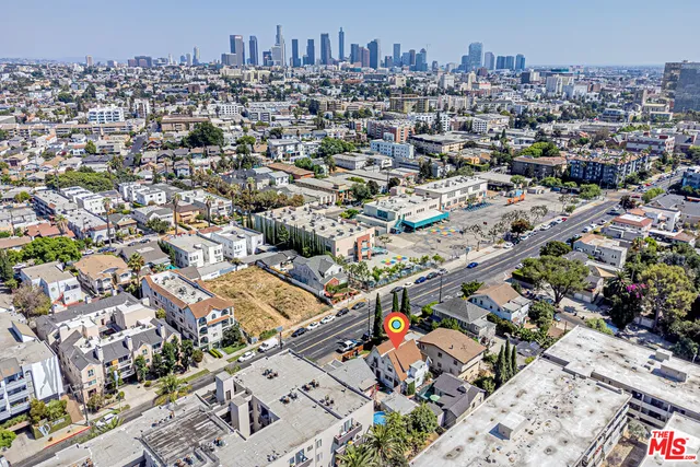 an aerial view of residential building and car parked