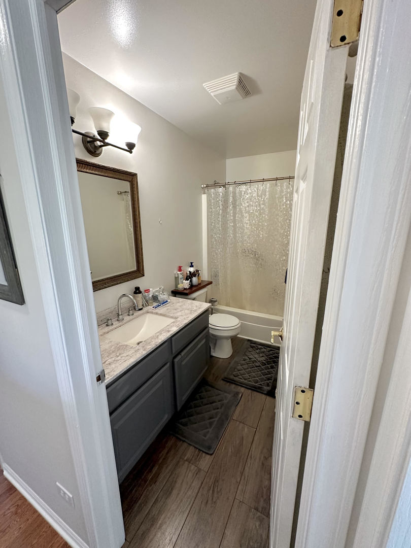 26668 Highway 83 Mundelein, IL 60060 - Photo 33 of 41 a bathroom with a granite countertop sink toilet and shower