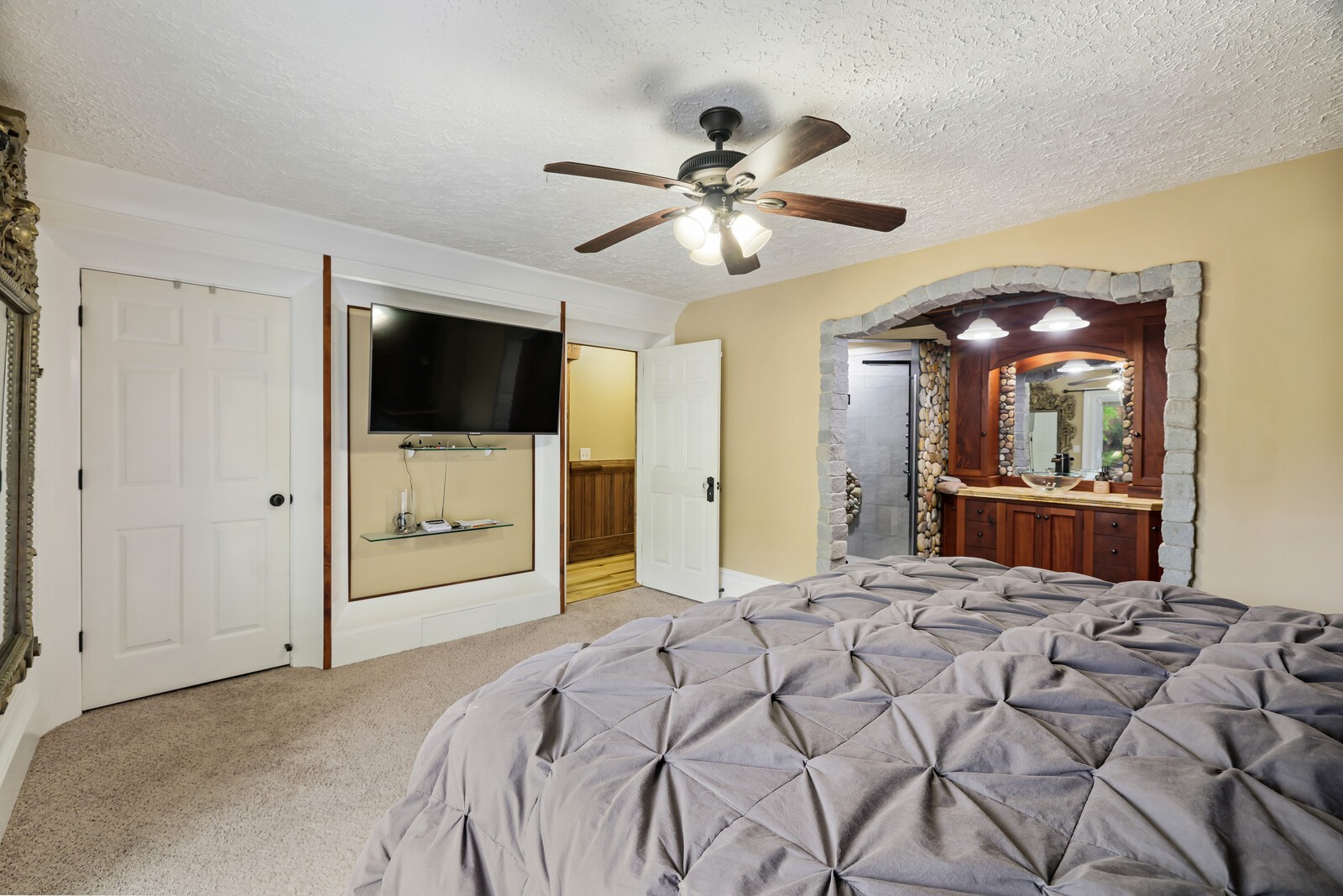 5700 Cane Ridge Road Antioch, TN 37013 - Photo 20 of 61 a bedroom with a bed and a flat tv screen on dresser