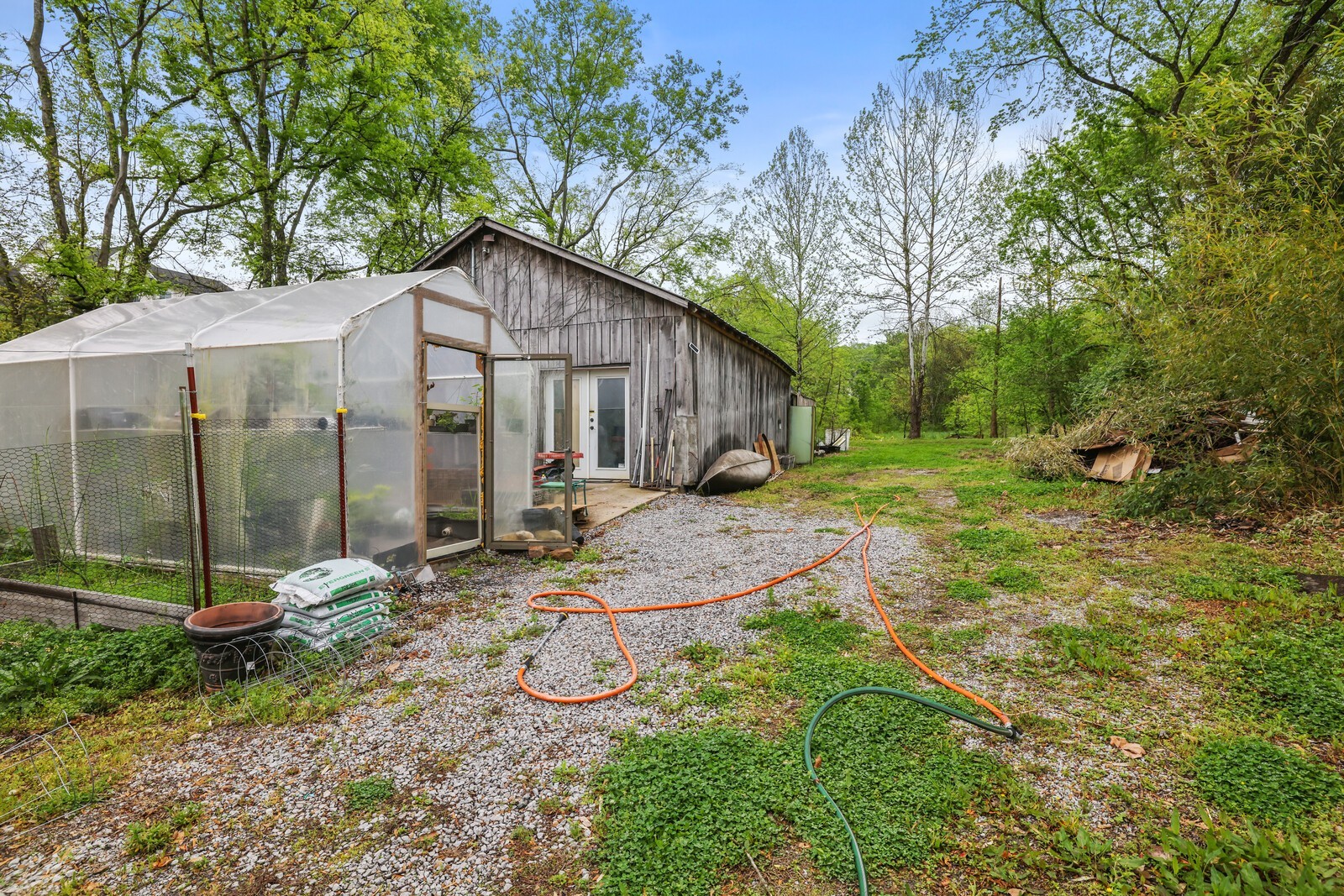 5700 Cane Ridge Road Antioch, TN 37013 - Photo 38 of 61 a backyard of a house with table and chairs under an umbrella