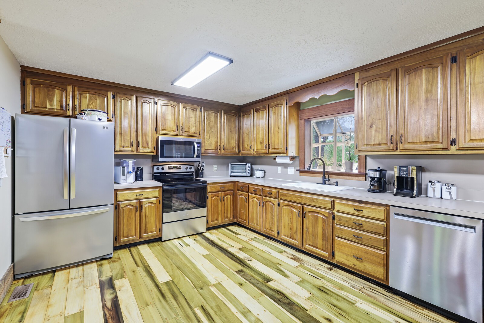 5700 Cane Ridge Road Antioch, TN 37013 - Photo 8 of 61 a kitchen with sink refrigerator and microwave