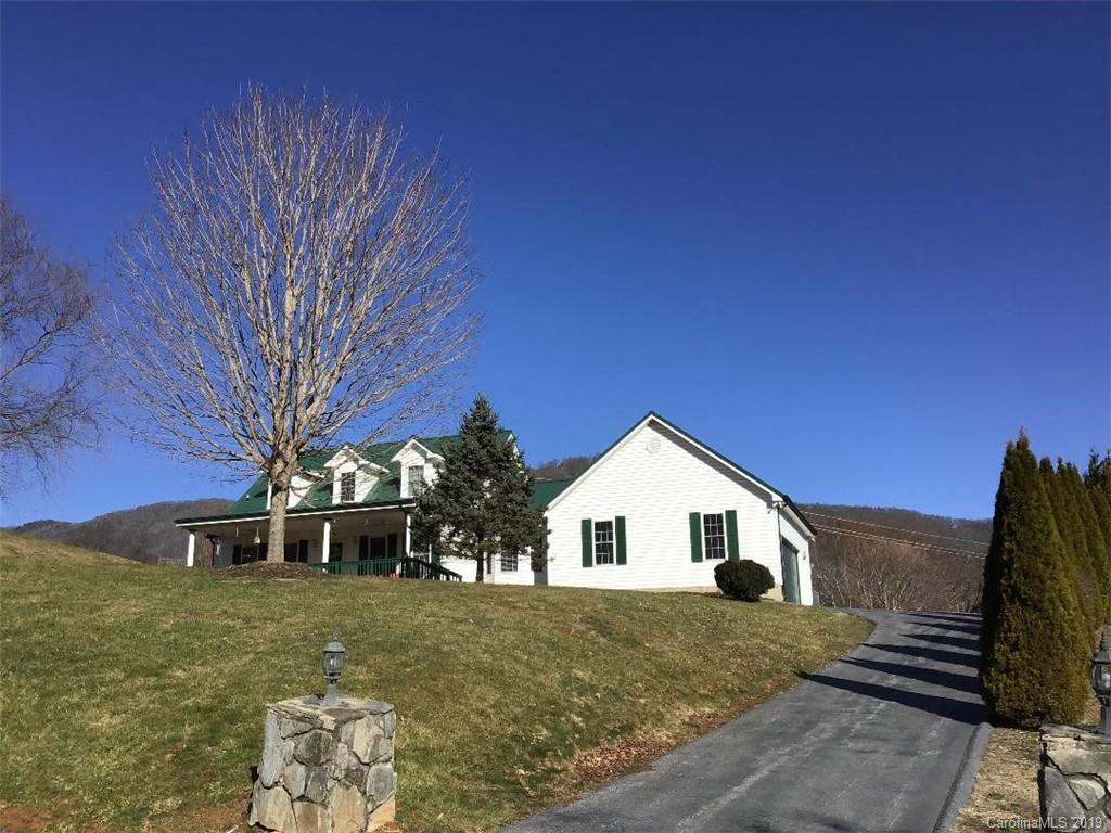 64 Squaw Ridge Road Waynesville, NC 28786 - Photo 1 of 32 a view of a house with a yard