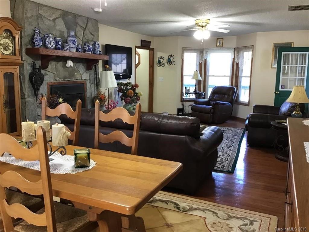 64 Squaw Ridge Road Waynesville, NC 28786 - Photo 6 of 32 a living room with furniture and wooden floor