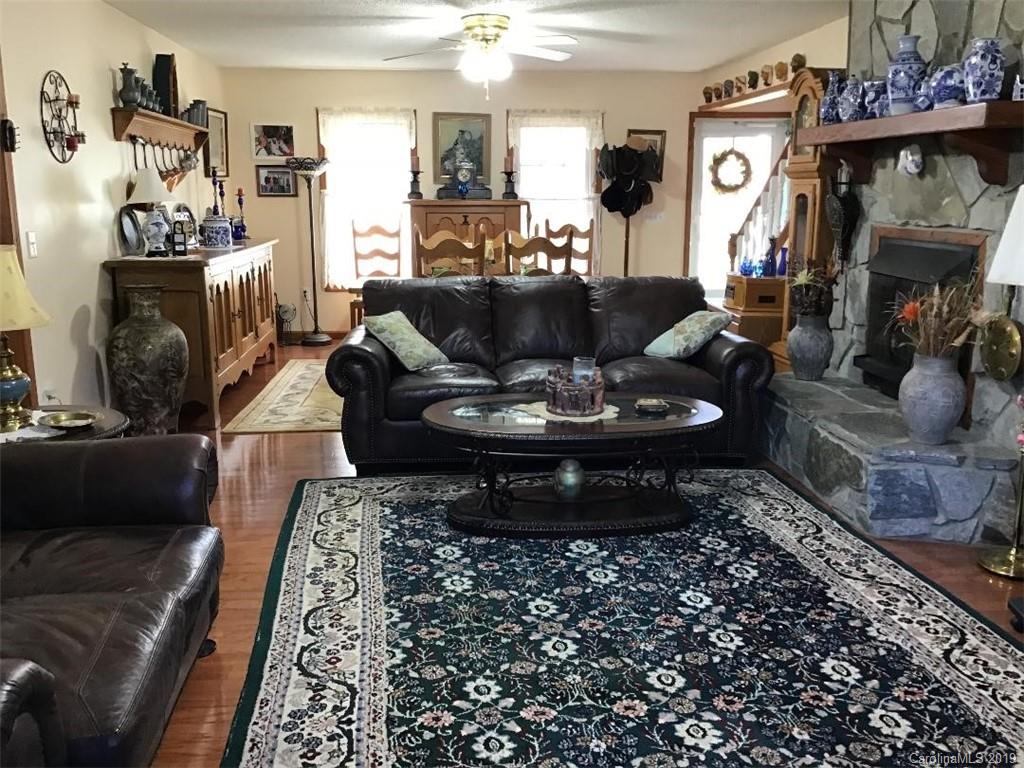 64 Squaw Ridge Road Waynesville, NC 28786 - Photo 7 of 32 a living room with furniture and a fireplace